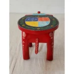 Handcrafted wood elephant stool with hand-painted bone inlay, used as side table in living room