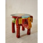 Handcrafted wood elephant stool with hand-painted bone inlay, used as side table in living room