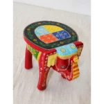 Handcrafted wood elephant stool with hand-painted bone inlay, used as side table in living room
