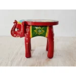 Handcrafted wood elephant stool with hand-painted bone inlay, used as side table in living room
