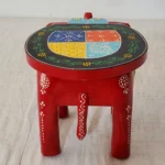 Handcrafted wood elephant stool with hand-painted bone inlay, used as side table in living room