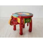 Handcrafted wood elephant stool with hand-painted bone inlay, used as side table in living room