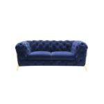Blue velvet loveseat with gold legs and diamond tufting in a living room