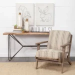 Solid acacia console table with live edge and black iron geometric base in an entryway