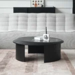 Goldoma modern round coffee table with hammered glass top and wood accents in a living room