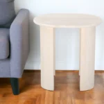 Goldoma natural solid wood oval end table with wabi-sabi farmhouse finish placed beside a sofa in a living room