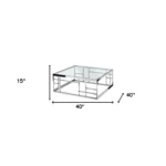 Goldoma 40-inch clear and silver glass coffee table with stainless steel frame in modern living room