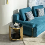 Goldoma modern round glass coffee table with gold stainless steel base in living room setting
