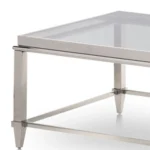 Goldoma 55-inch clear glass coffee table with silver steel frame in modern living room setting