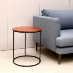Goldoma 22-inch reclaimed wood end table with black metal base in a cozy living room setting