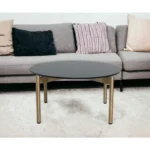 Goldoma 36-inch black and gold faux marble round coffee table in a modern living room setting