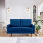 Blue velvet Chesterfield loveseat with dark brown wood legs – Goldoma 57-inch compact sofa for living room seating