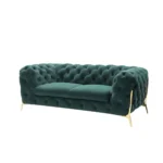 Goldoma 74-inch emerald velvet tufted Chesterfield loveseat with gold legs in a living room setting