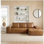 Goldoma brown faux leather cloud sectional sofa with tufted back and deep seat chaise in a modern living room