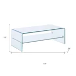 Goldoma 43-inch glass sled coffee table with brass frame and lower shelf in a modern living room