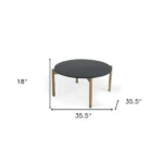 Goldoma 36-inch black and gold faux marble round coffee table in a modern living room setting