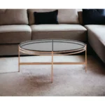 Goldoma 35 inch round glass coffee table with gold stainless steel frame and gray tempered glass top in living room