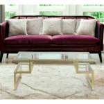 Goldoma 45-inch gold glass and steel coffee table with two shelves in a modern living room