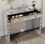 Goldoma modern glass top console table with 2 drawers in a silver finish, placed in an entryway