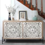 Goldoma vintage carved wood console table with floral doors and black metal base in a living room entryway as a storage sideboard