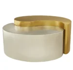 Modern gold coffee table with steel frame and metal top in a living room setting