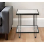Goldoma 22-inch black square glass top end table with lower shelf in a modern living room setting