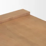 Solid wood coffee table with natural finish and sled base in a modern living room
