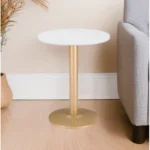 Goldoma 24-inch gold round end table with white veneer top and gold metal pedestal base in living room setting