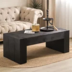 Goldoma 49-inch farmhouse coffee table in black engineered wood with antique finish, placed in a living room