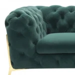 Goldoma 74-inch emerald velvet tufted Chesterfield loveseat with gold legs in a living room setting