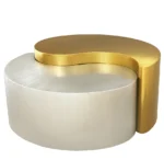 Modern gold coffee table with steel frame and metal top in a living room setting