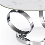 White ceramic coffee table 32 inch round with silver metal base in modern living room setting