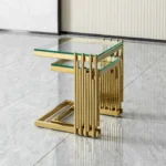 Goldoma gold coffee table set with tempered glass top and gold stainless steel frame in a modern living room
