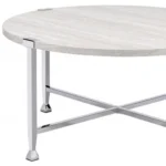 Goldoma 36-inch round coffee table with white paper veneer top and silver metal cross legs in a modern living room