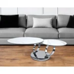 White ceramic coffee table 32 inch round with silver metal base in modern living room setting