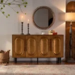 Goldoma gold sideboard buffet cabinet with solid wood arched doors and gold hardware in a modern dining room