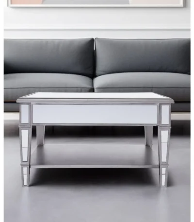 Goldoma 29 inch silver mirrored square coffee table with shelf and drawers in a modern living room