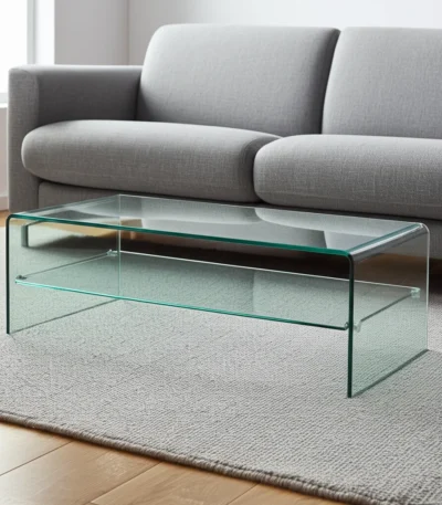 Goldoma 43-inch glass sled coffee table with brass frame and lower shelf in a modern living room