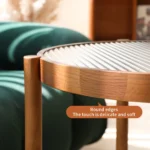 Modern farmhouse nesting coffee table set with ribbed glass tops and copper accents on a living room floor
