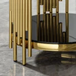 Goldoma modern round glass coffee table with gold stainless steel base in living room setting