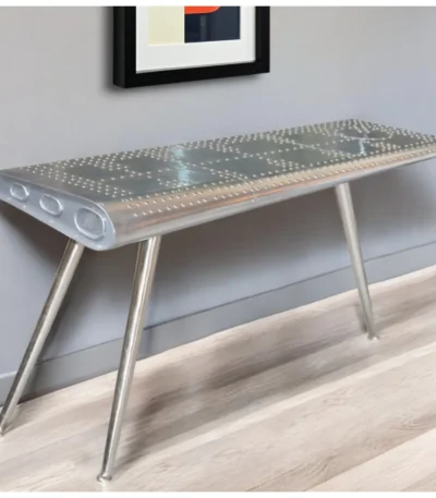 Goldoma 56-inch silver aluminum console table with three wood legs in a modern living room