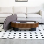 Goldoma 43.7 inch elliptical modern coffee table with hidden storage and removable tabletop in a living room setting