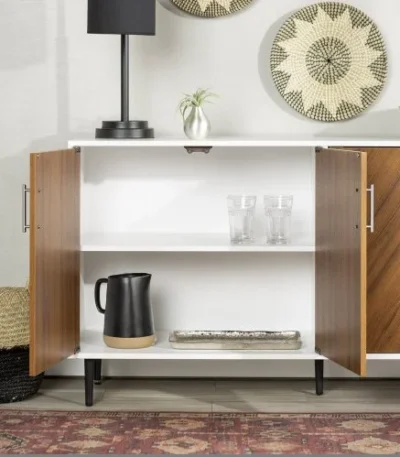 Goldoma mid-century console table with faux-bookmatch doors in white and teak, featuring two cabinets and metal legs, placed in a living room setting