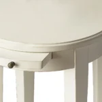Goldoma 26 inch white oval end table with shelf in a living room setting