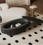 Goldoma 43.7-inch oval drum coffee table in walnut finish with solid wood top and MDF base on a modern living room floor