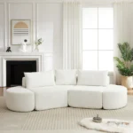 Goldoma 106.3-inch V-Shaped Convertible Modular Corner Sofa Set with chenille fabric, three throw pillows, and two curved ottomans in a modern living room