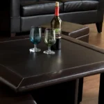 Goldoma coffee table and storage ottoman set with wood-grain veneer tabletop and dark brown faux leather ottomans