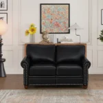 Goldoma black faux leather loveseat with memory foam cushions and wood legs in a modern living room