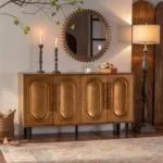 Goldoma gold sideboard buffet cabinet with solid wood arched doors and gold hardware in a modern dining room