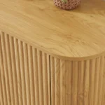 Modern oval coffee table with drawers and shelf in natural solid wood placed in living room